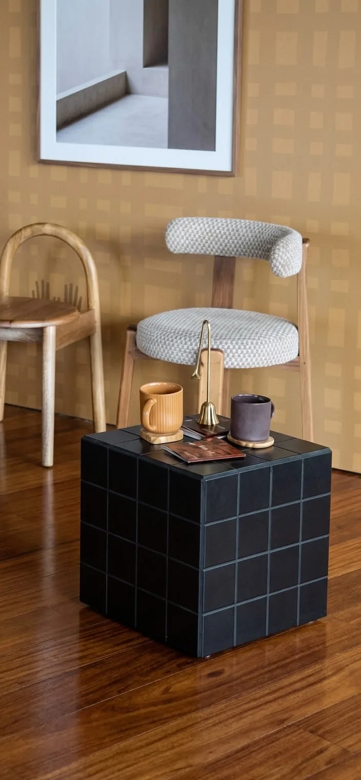 Black Cube side table styled beside a chair