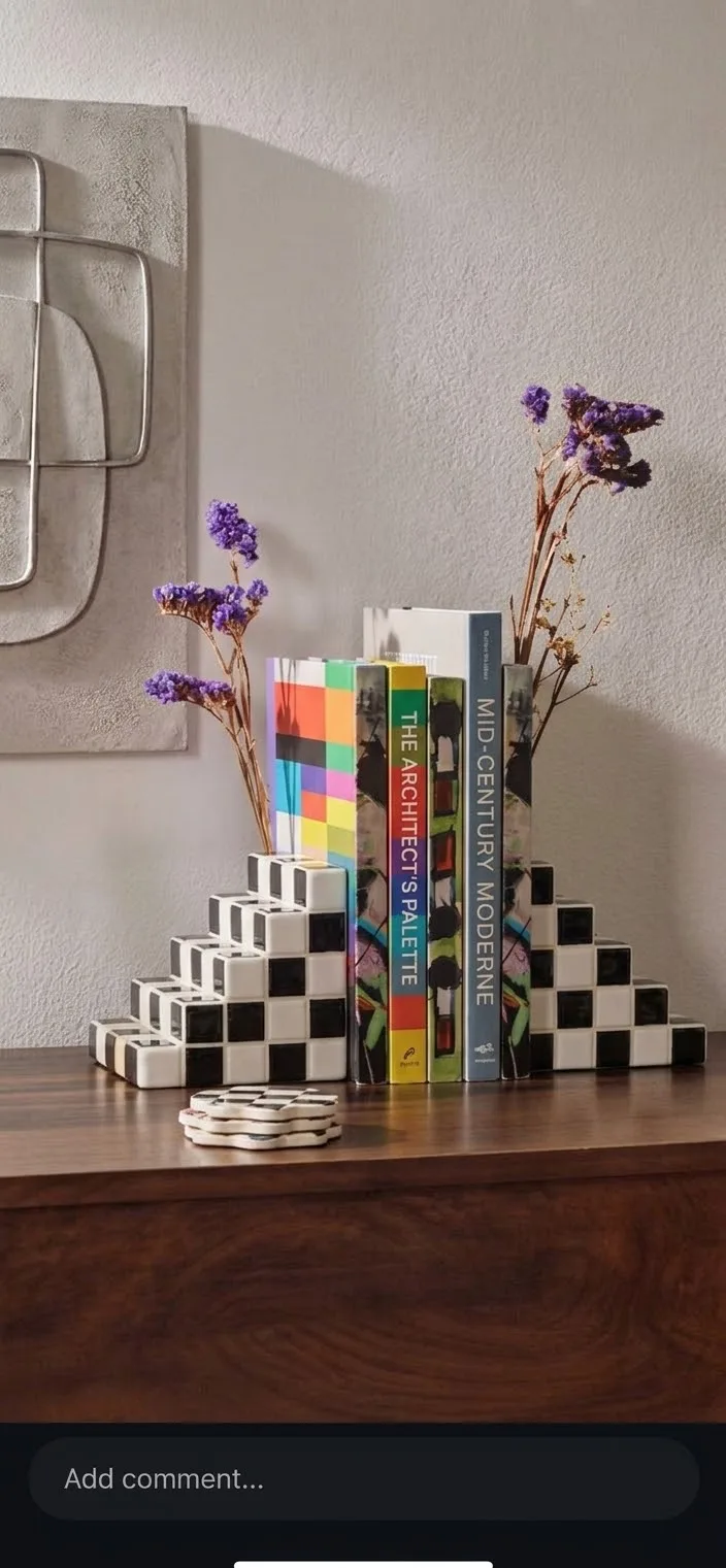 Checkered Totem bookends holding books on a shelf